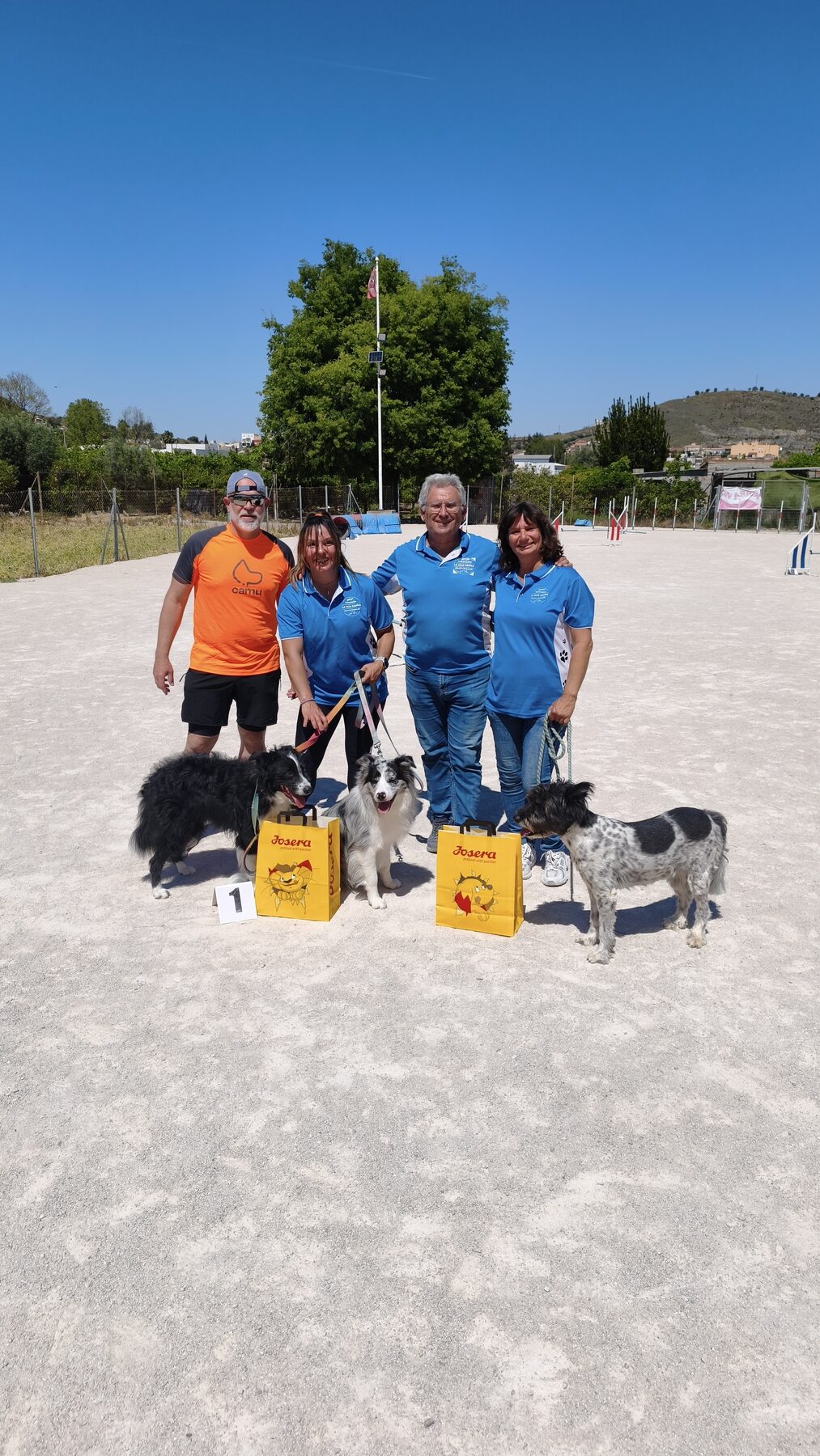 Personas y perros del club al final de una jornada junto al recorrido